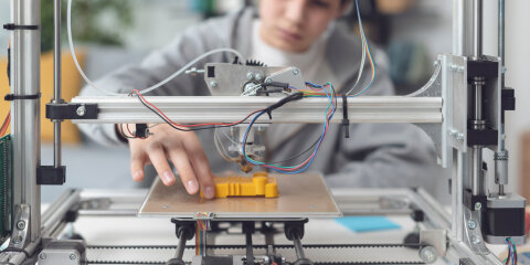 Boy printing a prototype using a 3D printer