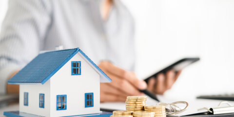 House model with real estate agent and customer discussing for contract to buy house, insurance or loan real estate background.